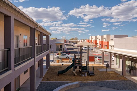 a playground in a courtyard of a building in a city